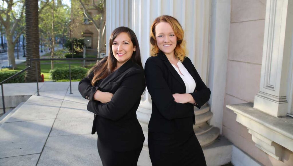 Natalie Gomez and Lauren Edwards standing on the courthouse steps.